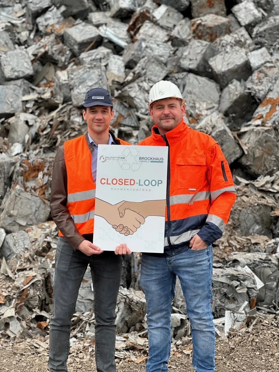 Employee in front of scrap pile