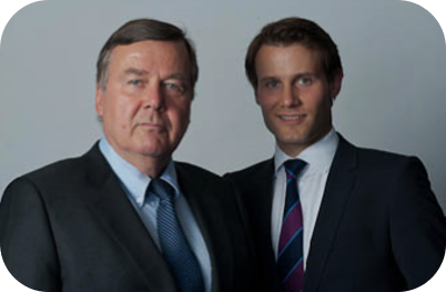 Portrait of Dirk Brockhaus and Caspar Brockhaus, both wearing dark suits and ties against a neutral background.
